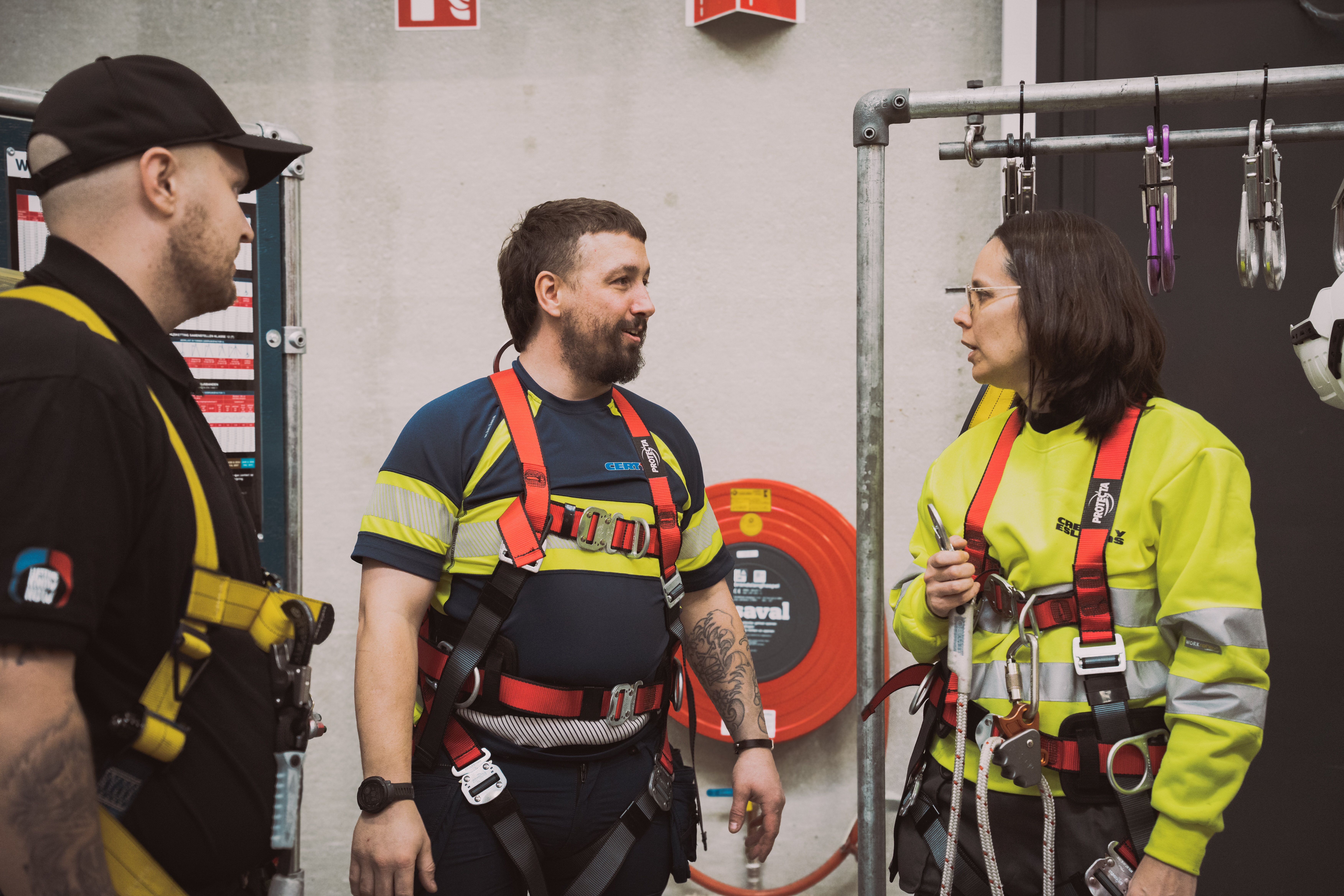 Employees wearing fall protection equipment